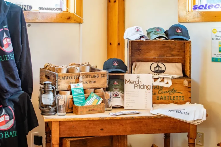 Bud Barn merch table with hats, pint glasses and tote bags